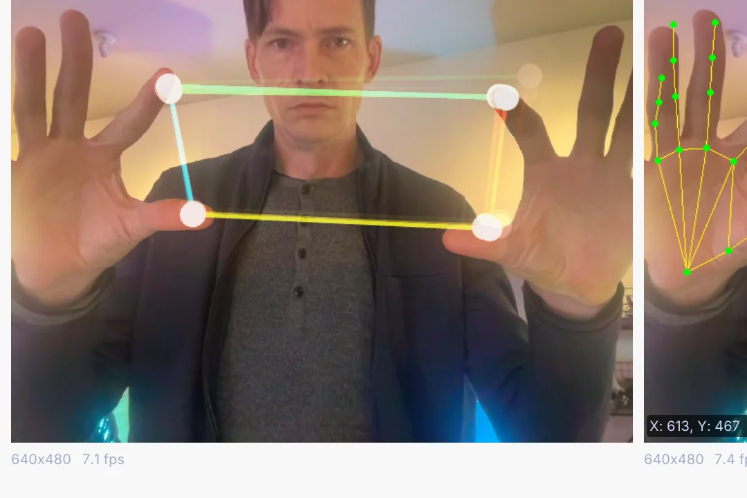 two hands held up to a webcam, playing a synth
