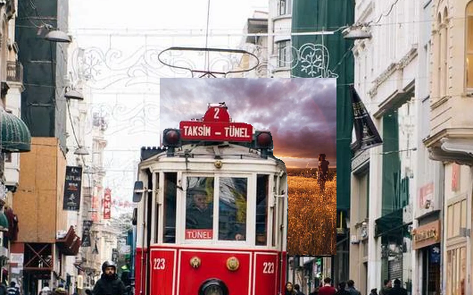 a print placed down the street, the tram nearer the camera in front of it