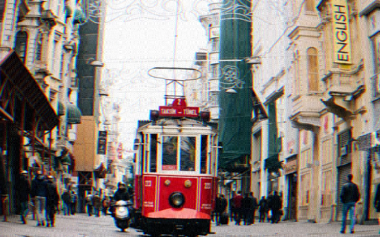 a street through a cheap lens, bent edges, color fringes, dark corners and grain