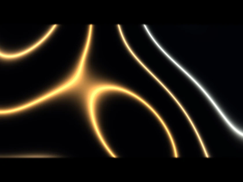 the picture on its own: gold and white lines of light on black, cut to the shape of the building
