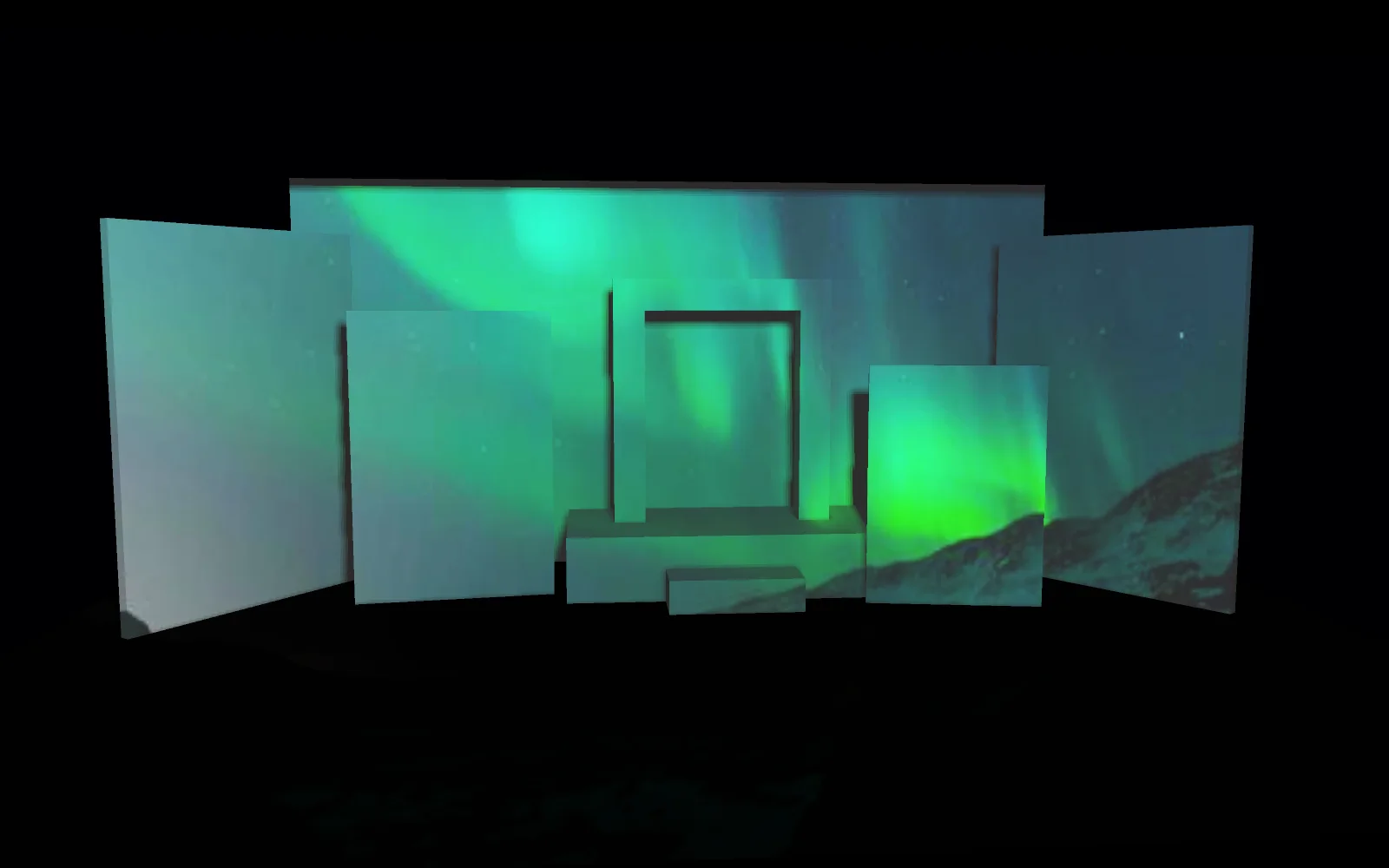 A model of a stage set: white flats, an arch and a platform, with a projector throwing the northern lights across all of them