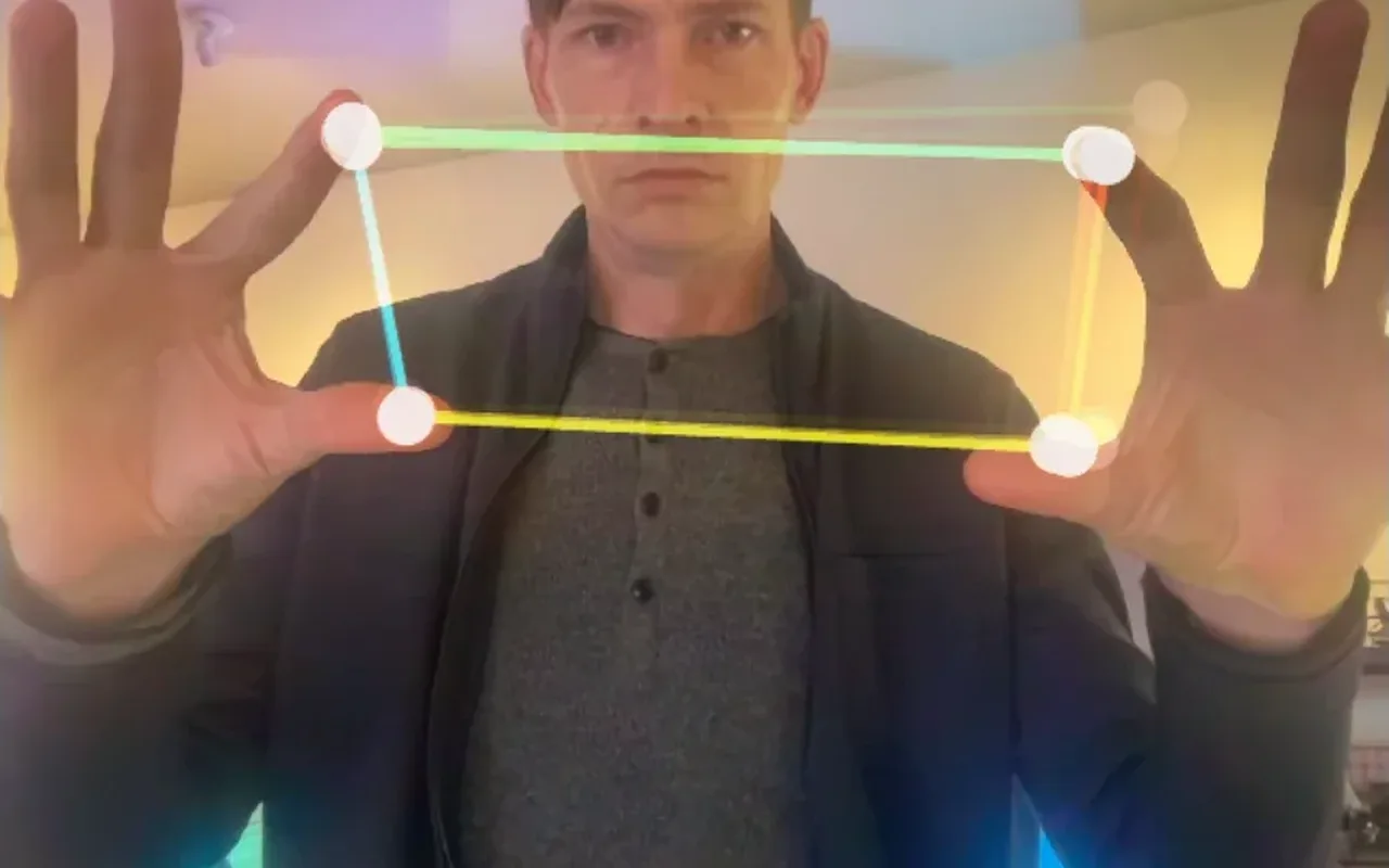 Two tracked hands framing a rectangle of light that sets the synth