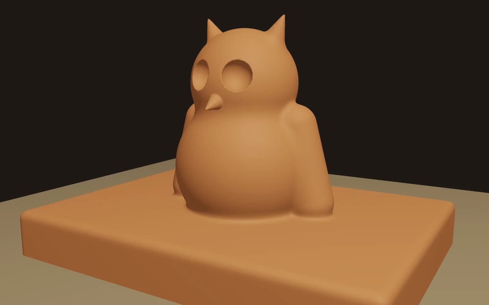 a clay owl built from ten shapes, with the eyes carved out
