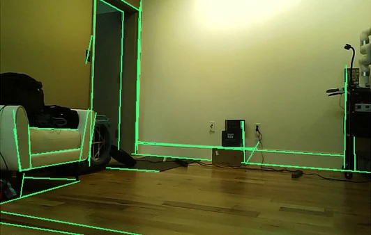 wall edges and frames traced in green over a camera picture of a room