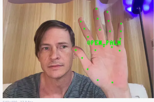 A plain webcam reading an open hand