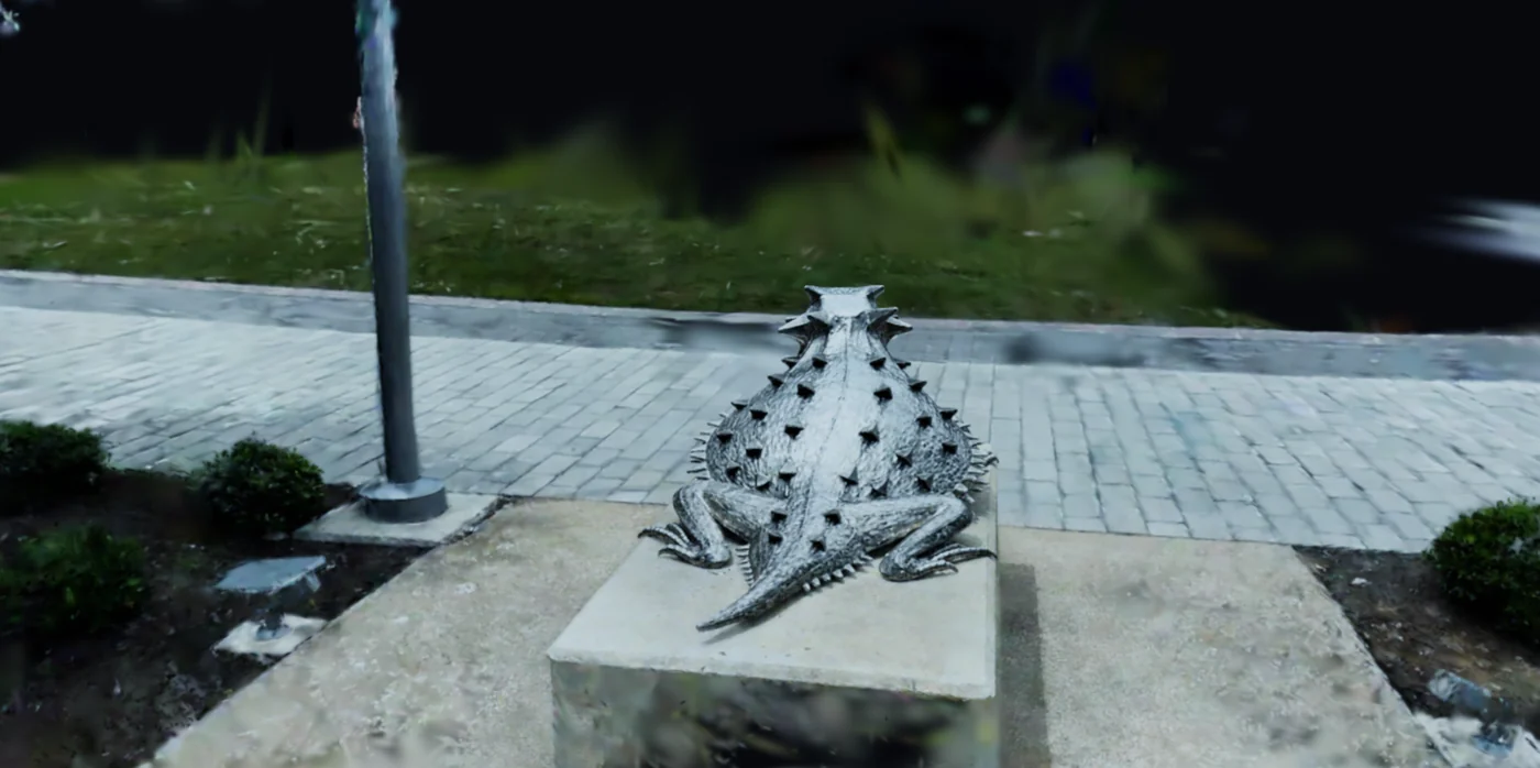 a sculpture on a paved path beside a lamp post, captured as a splat